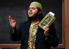 Student Colin Amato holds a copy of the Quran during a speech at the Nov. 17 Muslim Student Association event. ()